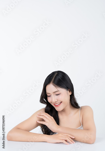 Beautiful portrait of young asian woman with healthy facial and body skin and glowing makeup for advertise skincare product.