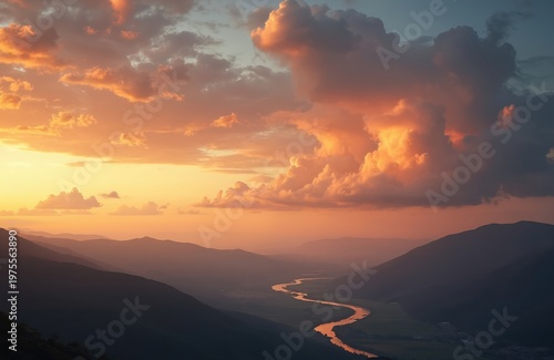 Orange clouds fill the sky at sunset above rolling hills and a winding river. Rich green fields border the water in a scenic valley. Serene natural landscape at dusk.