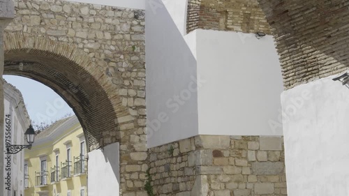 View of the Arco do Repouso, a historic city arch in Faro’s old town.