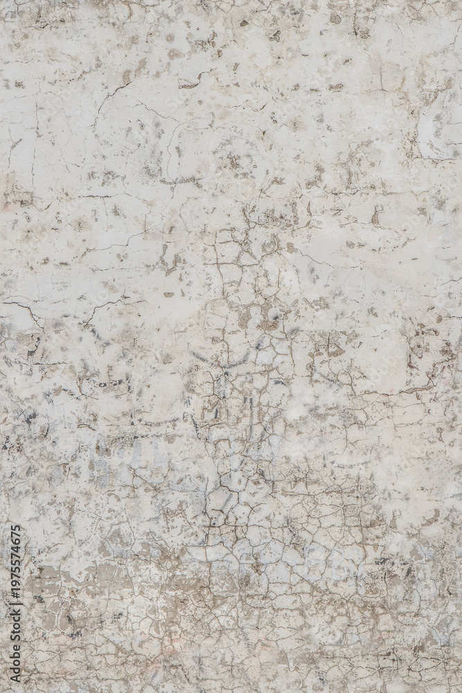 Obraz premium Cracked paint texture on a weathered white wall surface