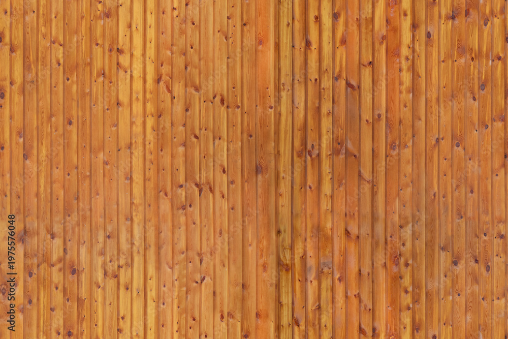 Naklejka premium Vertical wooden fence panels with natural texture outdoors during day