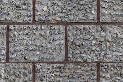 Fotografie Rough stone wall with flint cobbles in horizontal pattern