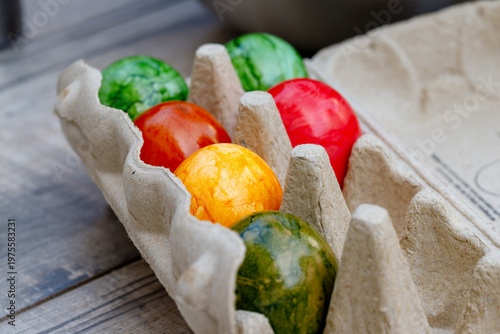 Colorful easter eggs in carton during holiday preparation