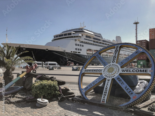 Classic cruise ship cruiseship liner Zaandam in port of Montevideo, Uruguay during South America cruising in summer with blue sky and containers and cargo