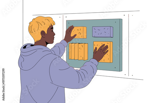 A young man installs acoustic panels on a wall in a sound absorption education studio. He focuses intently, demonstrating a hands-on learning activity. Modern, educational setting.
