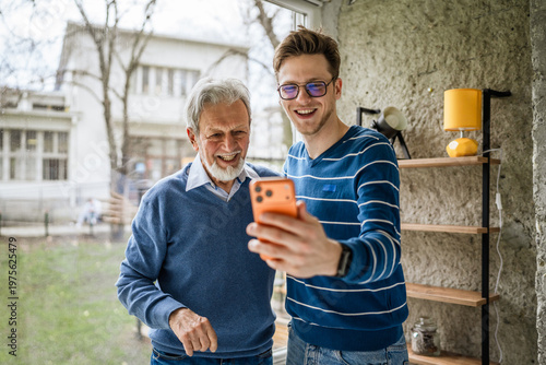 Konstfotografi Generational men enjoying video call on smart phone at home