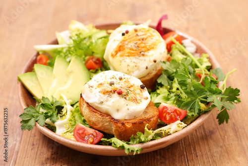 Fotografie Warm goat cheese salad with honey, avocado and cherry tomatoes on wooden table