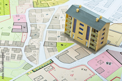 Imaginary cadastral map and general urban plan with cadastral parcels, urban destinations, vacant land plots and condominium residential building