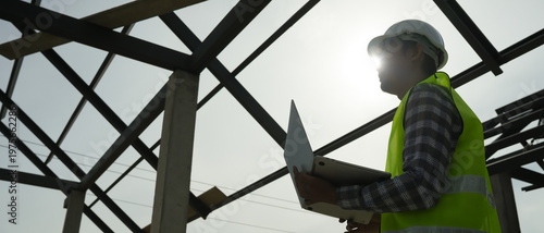 inspector or engineer is inspecting construction and quality assurance new house using computer. Engineers or architects or contactor work to build the house before handing it over to the homeowner
