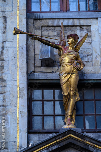 Golden angel with trumpet on building