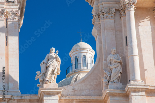 Closeup view of the statues of the Evangelists in the upper part of the baroque San Nicolò Cathedral in Noto, Sicily. 