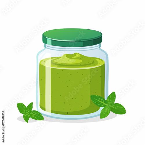 Small glass jar of green pesto sauce is isolated on a plain white background for gourmet food.