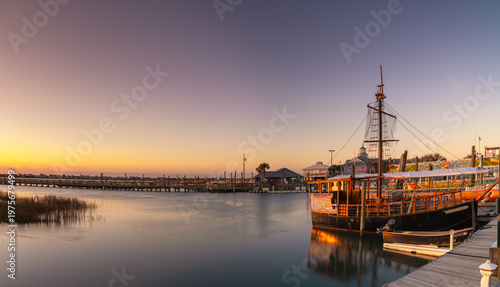 sunrise over Murrells Inlet Marsh Walk and the salt marsh with boats in the foreground