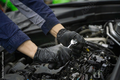 Mechanic Wearing Black Gloves Fixes Car Engine With Wrench