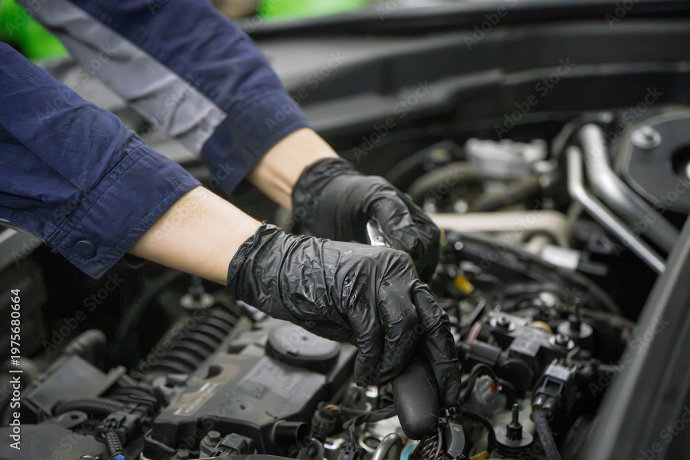 Fototapeta premium Mechanic Wearing Black Gloves Servicing Engine Bay