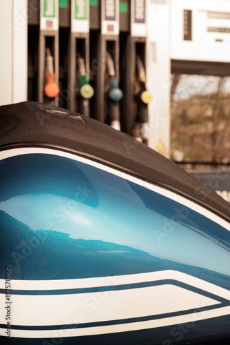Close up of custom motorcycle fuel tank with blue metallic paint and design detail