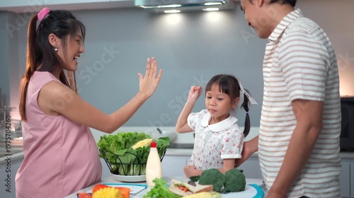 Pregnant woman and husband with little daughter cooking together
