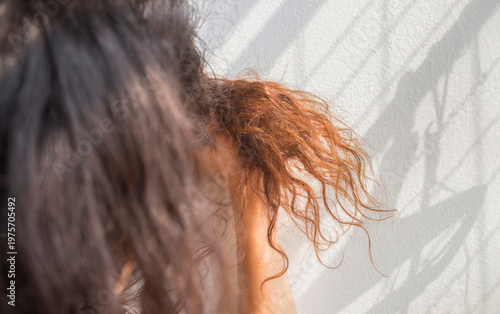 Close up of woman's hair in the morning sunlight with sunbeam