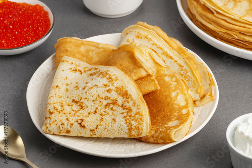 Freshly baked pancakes with sour cream and red caviar