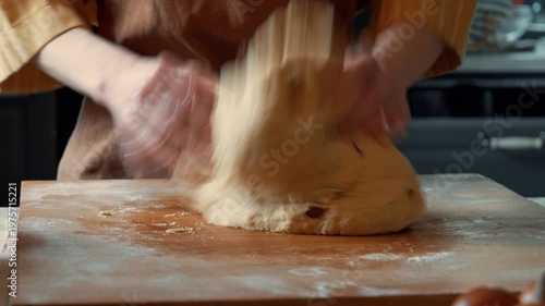 Woman in apron mixing raisin dough for Easter bread in home kitchen