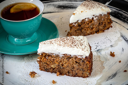 Carrot cake with almond flour and walnuts, topped with whipped cream. Gluten-free.
