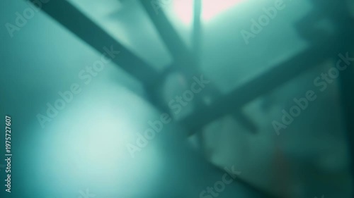 Transparent spheres and air bubbles are moving in clear blue water, creating an abstract liquid background with a dynamic scientific or futuristic concept