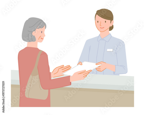 Senior woman receiving document from female staff at hospital reception