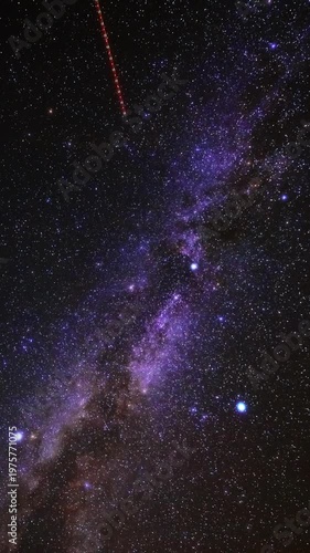 Constellations, stars, Milky Way with airplane and satellite trails. Time-lapse video.