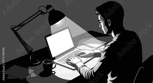Man working on laptop at night with desk lamp