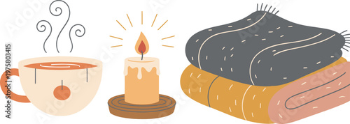 Hygge cozy lifestyle concept with hot drink, candle, and books