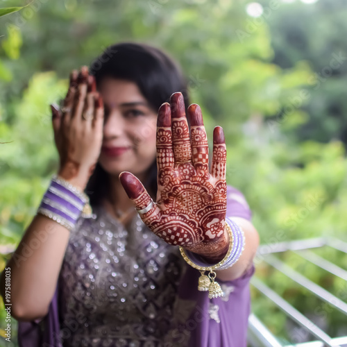Beautiful woman dressed up as Indian tradition with henna mehndi design on her both hands to celebrate big festival of Karwa Chauth, Karwa Chauth celebrations by Indian woman for her husband