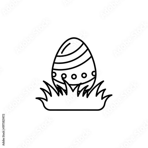 Decorated Easter egg in grass.