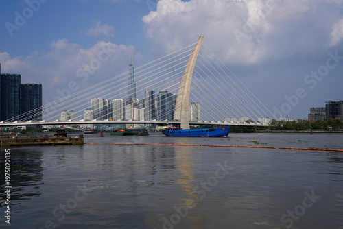 Ba Son Bridge over Saigon River with modern skyline in Ho Chi Minh City, Vietnam