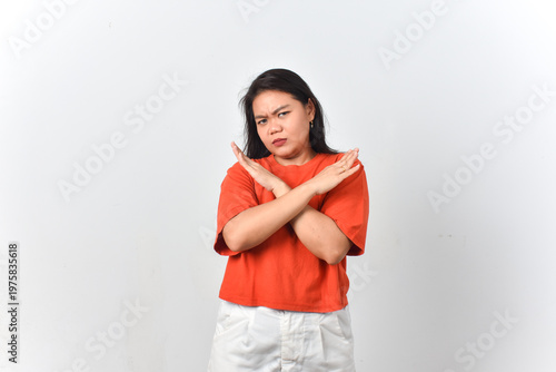 Photos Determined woman showing cross arms X sign as refusal