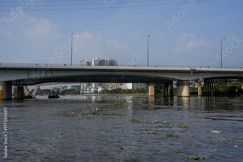 Ba Son Bridge over Saigon River with modern skyline in Ho Chi Minh City, Vietnam
