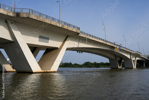 Ba Son Bridge over Saigon River with modern skyline in Ho Chi Minh City, Vietnam