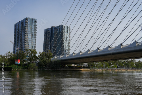 Ba Son Bridge over Saigon River with modern skyline in Ho Chi Minh City, Vietnam