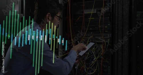Data center engineer crouching tapping tablet reseating cables as overlay tracking network traffic
