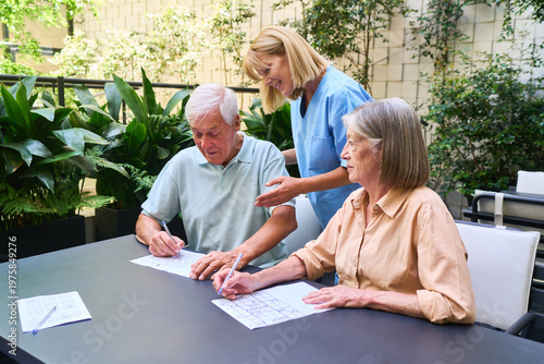 Photos Senior people engaging in activities with support in a rehabilitation facility