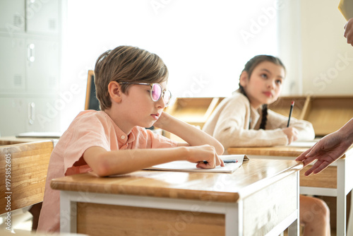 Quadro em tela Schoolboy looking bored and distracted in classroom