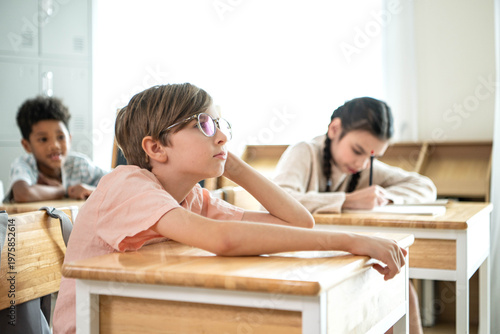 Photography Schoolboy looking bored and distracted in classroom