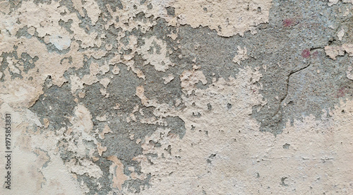 Old weathered concrete wall with peeling paint texture background and cracked surface for urban grunge style architectural design and renovation concept