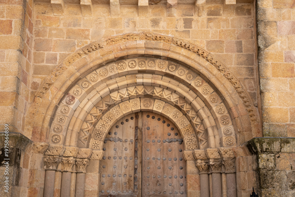 Fototapeta premium Intricate stone archway with wooden doors.. Ávila, Spain