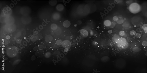 Shiny silver raindrops on a blue winter window glow with bright bokeh light and a blurry holiday glitter pattern