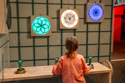 Photography Child Exploring Interactive and Glowing Shapes.