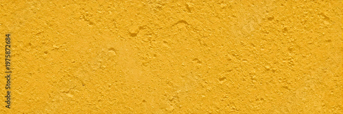 Vibrant Yellow Concrete Wall Texture with Rough Stucco Surface and Gritty Stone Details