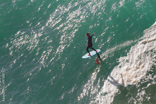 Tableau sur toile High angle view of a man hydrofoil surfing on turquoise ocean water