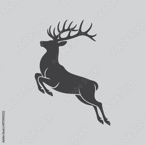 Leaping stag silhouette with prominent antlers on gray background, image feature