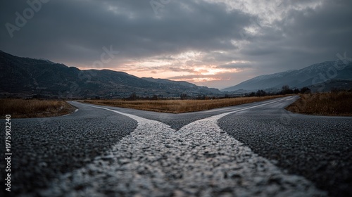 divergence. A fork in the road splitting two directions under atmospheric lighting, symbolizing choice. wellbeing guides, coaching materials, designed for coaching and self-improvement content.