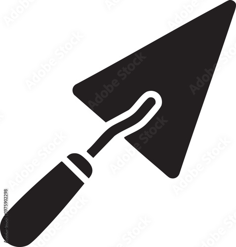 A trowel lies on a surface with its blade and handle visible.